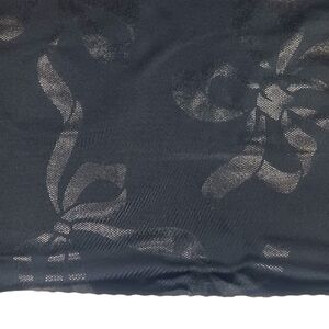 Black Shiny Microdot Bow Print on Black Spandex Fabric.